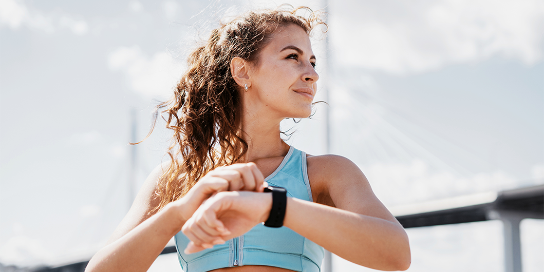 female looking at smart watch 